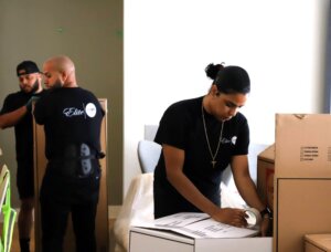 6 Ways to Cut Down on the Time It Takes to Move in NYC Elite white glove movers packing boxes and moving furniture 300x228 6 Ways to Cut Down on the Time It Takes to Move in NYC