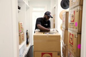 Automation Techniques How Are They Effective in Moving Homes? FlatRate Mover labeling a moving box 300x200 Automation Techniques How Are They Effective in Moving Homes?
