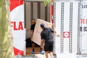 Automation Techniques How Are They Effective in Moving Homes? FlatRate Movers loading a large box into moving truck 300x200 Automation Techniques How Are They Effective in Moving Homes?