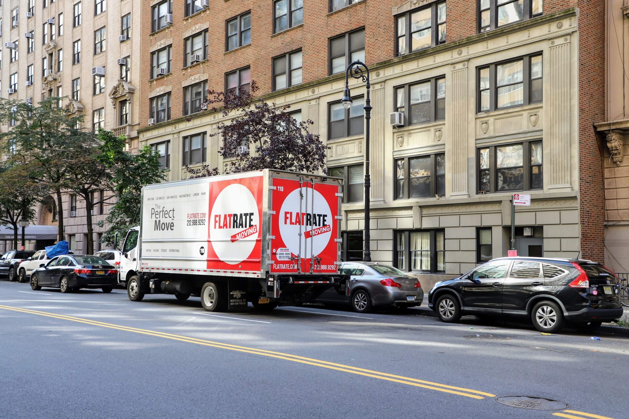 Flatrate truck in front of a building