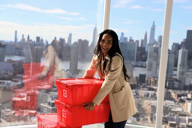 Woman holding reusable bin