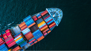 A boat carries shipping containers